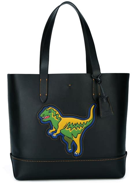 coach bag with dinosaur.